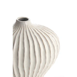 Ivory ribbed ceramic vase with rounded silhouette and modern textured design close up