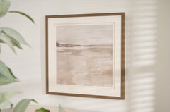 Framed abstract landscape print titled "Misty Daybreak" featuring soft gray, beige, and white tones with a minimalist design, displayed in a wood-look frame and white matting.