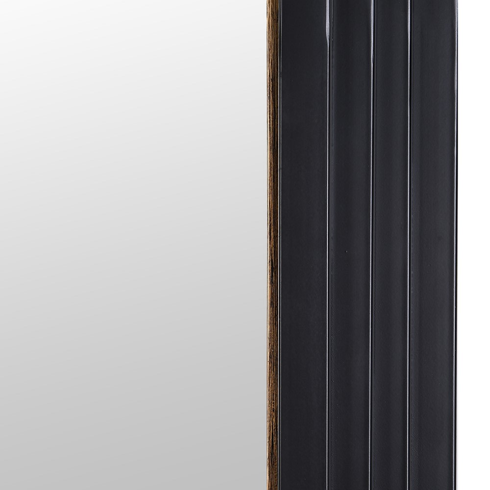 Full-length arch mirror with black frame and gold detailing close up