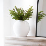 Pine cone spray in a round vase