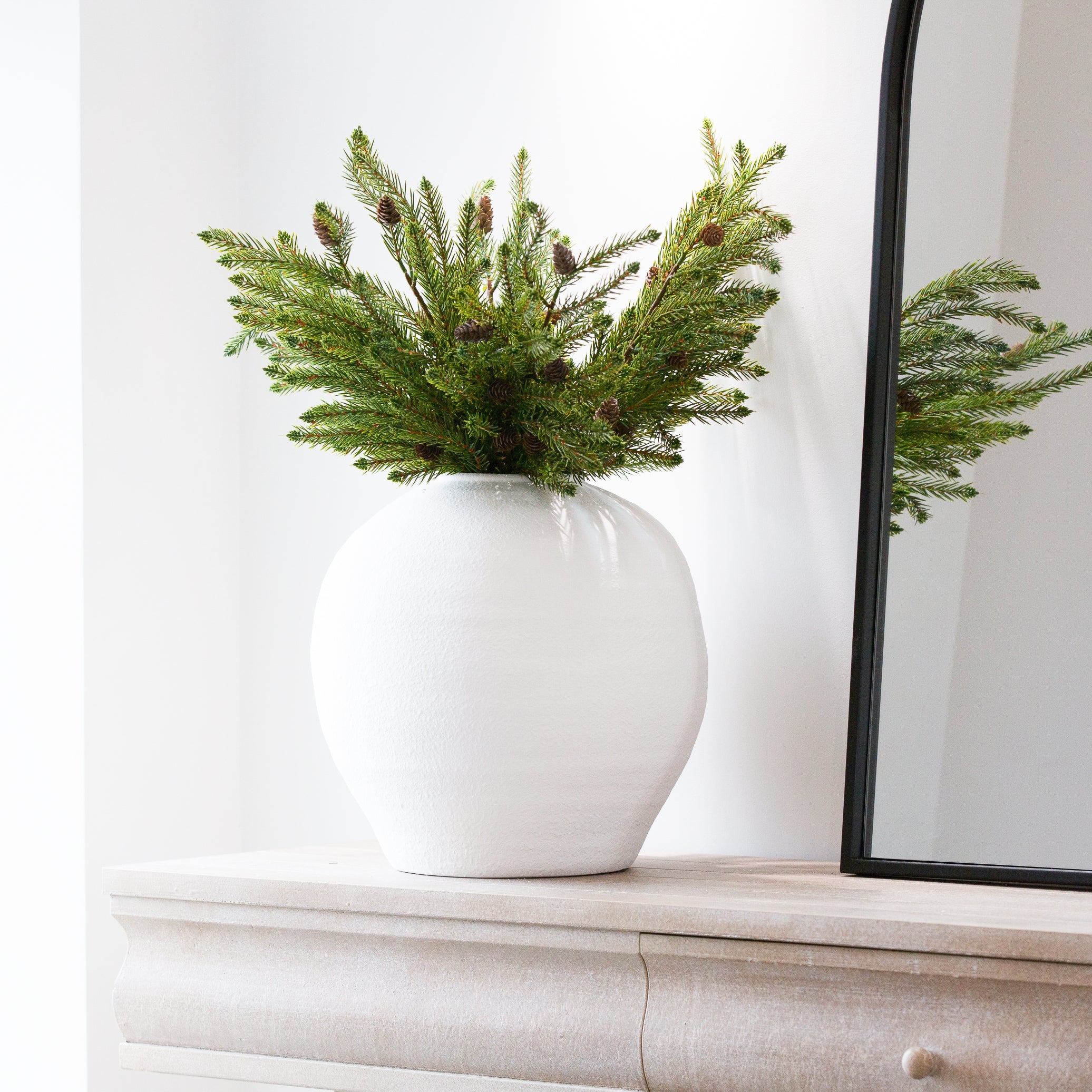 Pine cone spray in a round vase