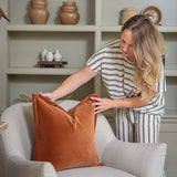 Elevate your space with this season’s must-have: our rust velvet cushion, celebrated for its rich orange-brown hue and luxurious texture. With a mo-hair-like finish and a 2.5 cm tailored cuff, this cushion adds depth and sophistication to any room. Its structured elegance pairs effortlessly with warm neutrals like Almond for a subtle, refined look, or makes a bold statement when styled with textured Boucle. A stunning accent for modern, Scandinavian, or earthy interiors.