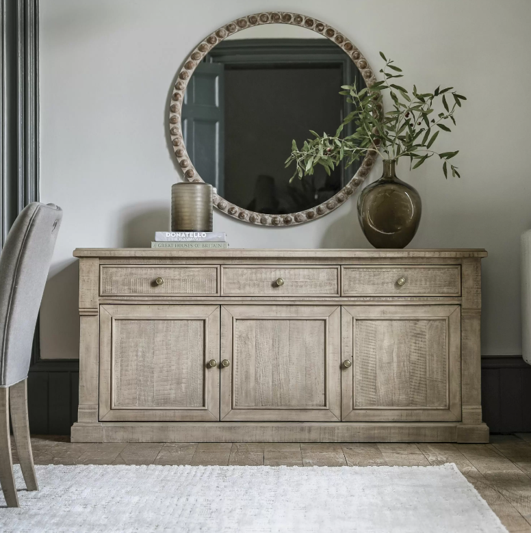 Add timeless charm and functional storage to your home with the Rustic Oakridge 3-Drawer Sideboard. Crafted from pine with a natural weathered finish, this beautifully designed sideboard showcases classic detailing and a rustic aesthetic that complements farmhouse, cottage, and traditional interiors.
Featuring three spacious drawers and three cabinet doors, the Oakridge sideboard offers ample storage for dinnerware, linens, or living room essentials. The hand-finished texture and antique brass knobs enhanc