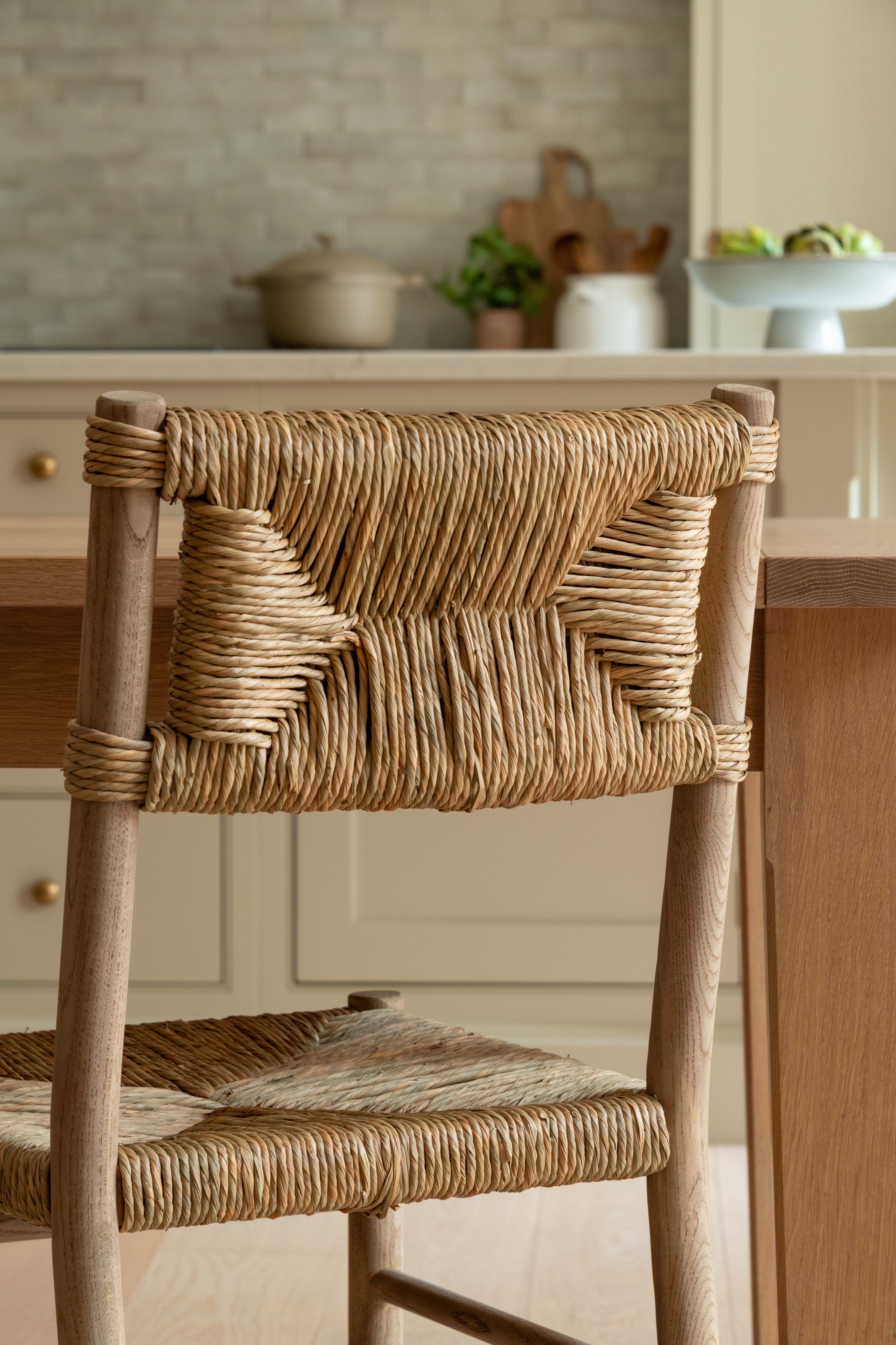 Woven chair in a kitchen setting with a neutral color palette