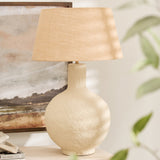 Textured papier mache lamp with natural shade on wooden console