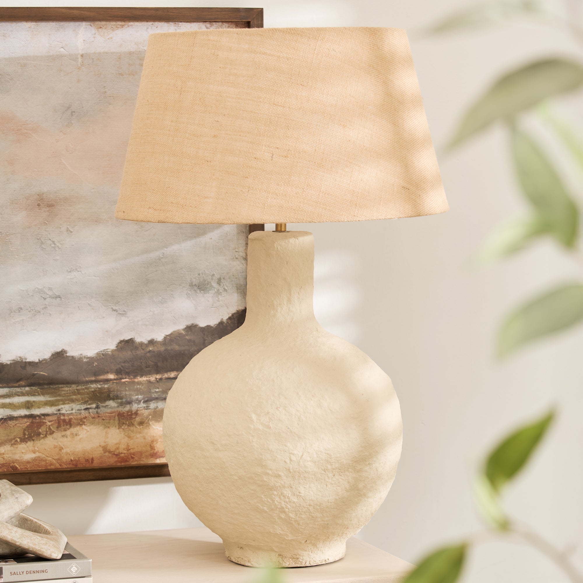 Textured papier mache lamp with natural shade on wooden console