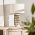 Samsara Bouclé Table Lamp styled on light wood console with modern artwork and décor