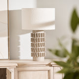 Samsara Bouclé Table Lamp styled on light wood console with modern artwork and décor