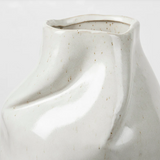 White ceramic vase with textured surface on a light gray background