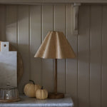 Soleil Rattan Lamp on a marble-topped wooden dresser with pumpkins and cutting boards
