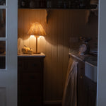 Soleil Rattan Lamp glowing warmly in a cozy rustic kitchen corner