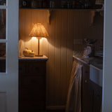Soleil Rattan Lamp glowing warmly in a cozy rustic kitchen corner