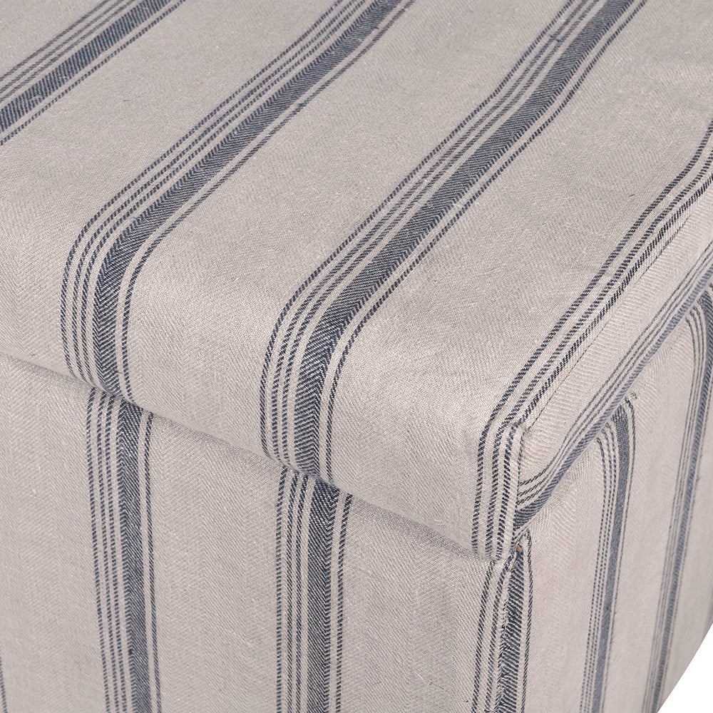 Close-up of a fabric with blue stripes on a beige background