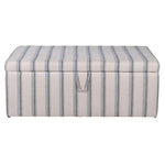 Striped storage ottoman on a white background