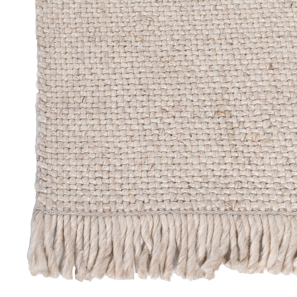 Close-up of handwoven rug texture with fringe detail