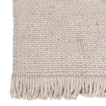 Close-up of handwoven rug texture with fringe detail