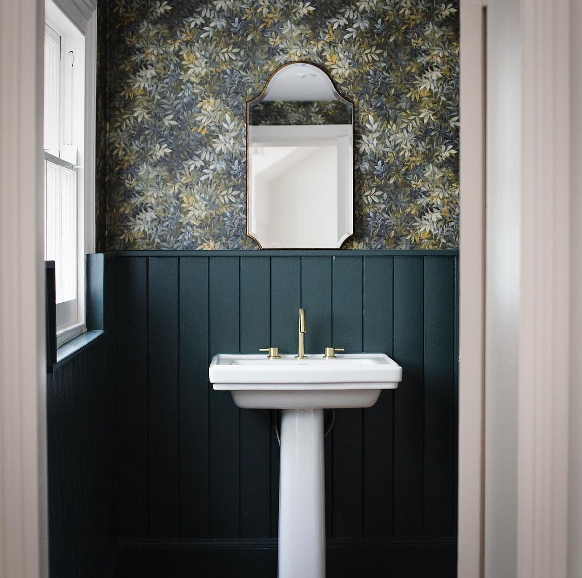 A beautiful frameless arched mirror.