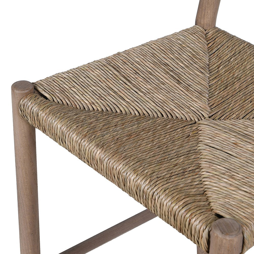 Close-up of woven seagrass seat detail on rustic bar stool