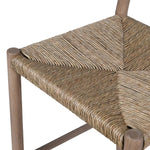 Close-up of woven seagrass seat detail on rustic bar stool