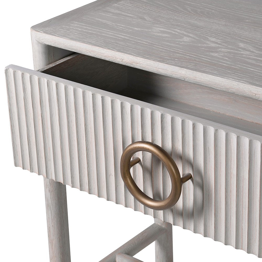 The Zahara white oak console table features two drawers and is crafted from premium oak and oak veneer and finished in an off white with a fluted detail.
Complete with a gorgeous round handle finished in bronze