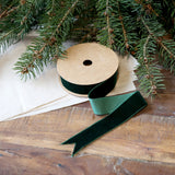 Forest green velvet ribbon roll on wooden table with fir branches – 5m x 2.5cm craft and gift ribbon