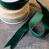 Spool of green ribbon on a wooden surface