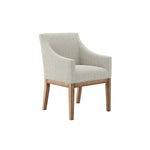 The Marisia Linen Effect Dining Chair boasts a warm wooden frame and bisque linen upholstery. Its spacious seat, built-in arms, and traditional design provide both comfort and timeless elegance in a versatile neutral tone.