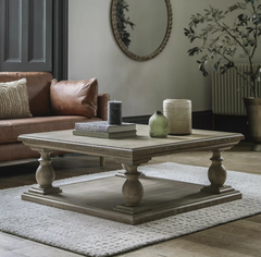 Elevate your living room with this beautifully crafted pine coffee table, designed to blend timeless rustic charm with contemporary sophistication. Featuring a solid pine wood construction and a classic pedestal base with turned legs, this statement piece adds warmth and character to any décor style—from traditional to modern farmhouse.
The spacious square tabletop offers ample room for books, candles, and decorative accents, while the sturdy lower shelf enhances stability and adds functional display space