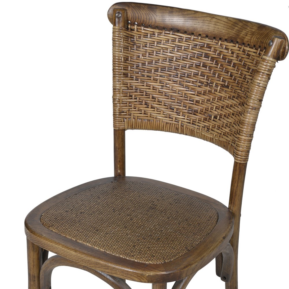 Close-up of handcrafted elm and woven rattan dining chair backrest