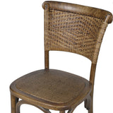 Close-up of handcrafted elm and woven rattan dining chair backrest