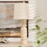 Indulge in the timeless charm of our travertine stone table lamp. Each piece is crafted with precision, creating a stunning balance between the pure white marble base and the soft, elegant linen shade. Add an air of sophistication to any room with this luxurious and exclusive lamp.