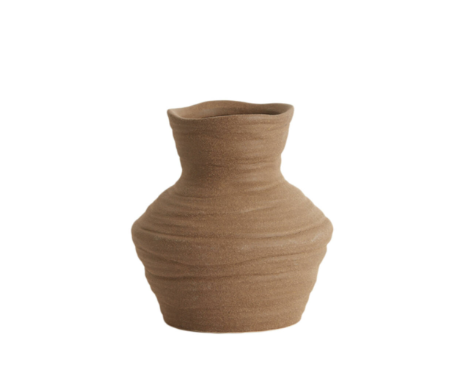 The Terra Forma Vase is a handcrafted ceramic piece inspired by the natural contours of wind-shaped desert landscapes. Its earthy brown finish and organic silhouette bring a grounded, rustic elegance to any space. Perfect for dried floral arrangements or as a standalone statement piece, this vase adds texture and warmth to minimalist and bohemian interiors alike. Each vase is uniquely shaped, embracing subtle imperfections that highlight its artisanal charm.