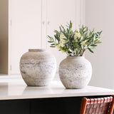 Rustic stoneware pot with textured finish styled on a kitchen island