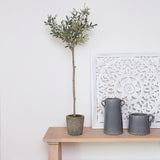 faux olive tree on a console table