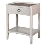 A white wash bedside table with rattan finish and a single drawer, alongside a lower shelf.