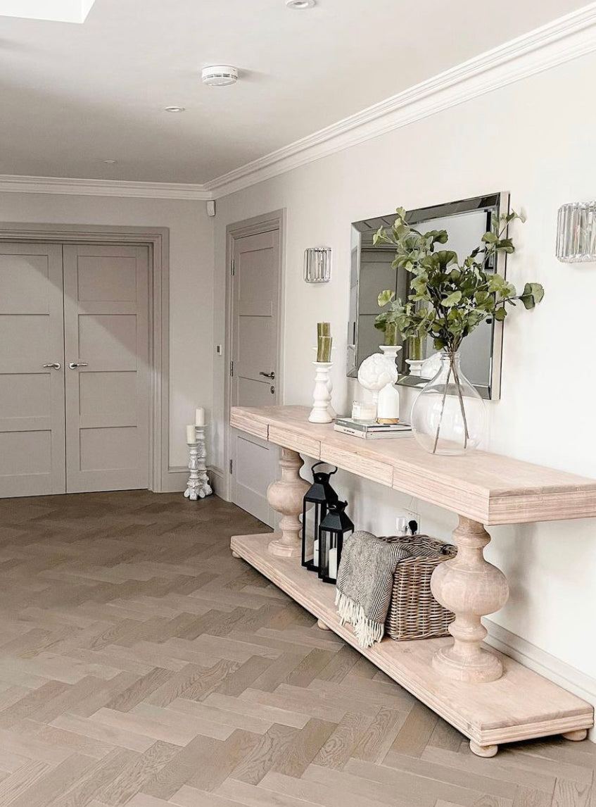 Large acacia wood console table supported by two balustrades