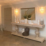Large acacia wood console table supported by two balustrades