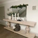 Large acacia wood console table supported by two balustrades