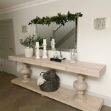 Large acacia wood console table supported by two balustrades