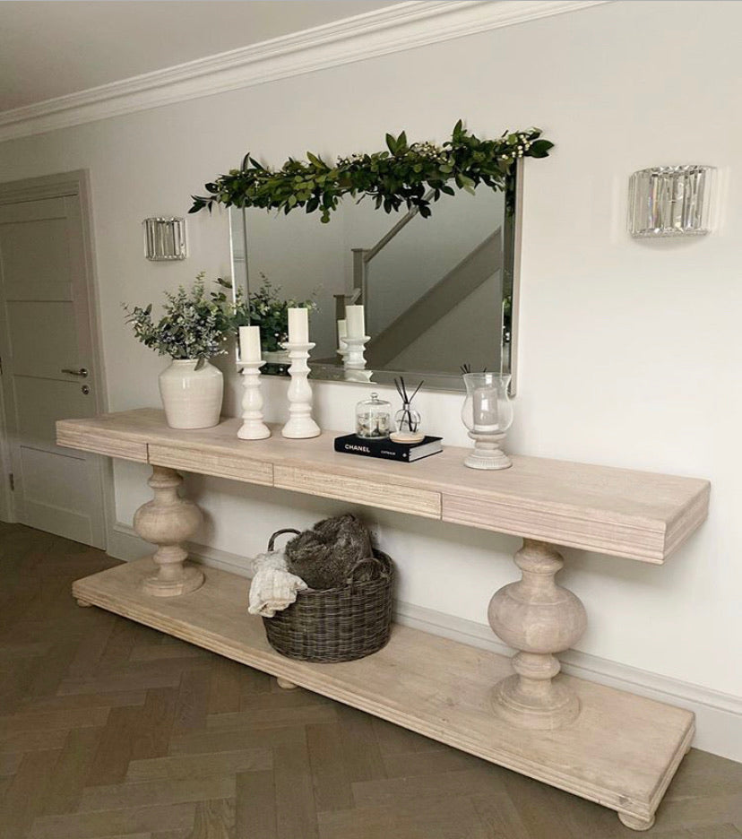 Large acacia wood console table supported by two balustrades