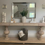 Large acacia wood console table supported by two balustrades