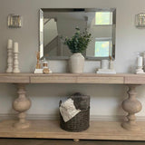 Large acacia wood console table supported by two balustrades