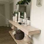 Large acacia wood console table supported by two balustrades