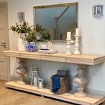 Large acacia wood console table supported by two balustrades