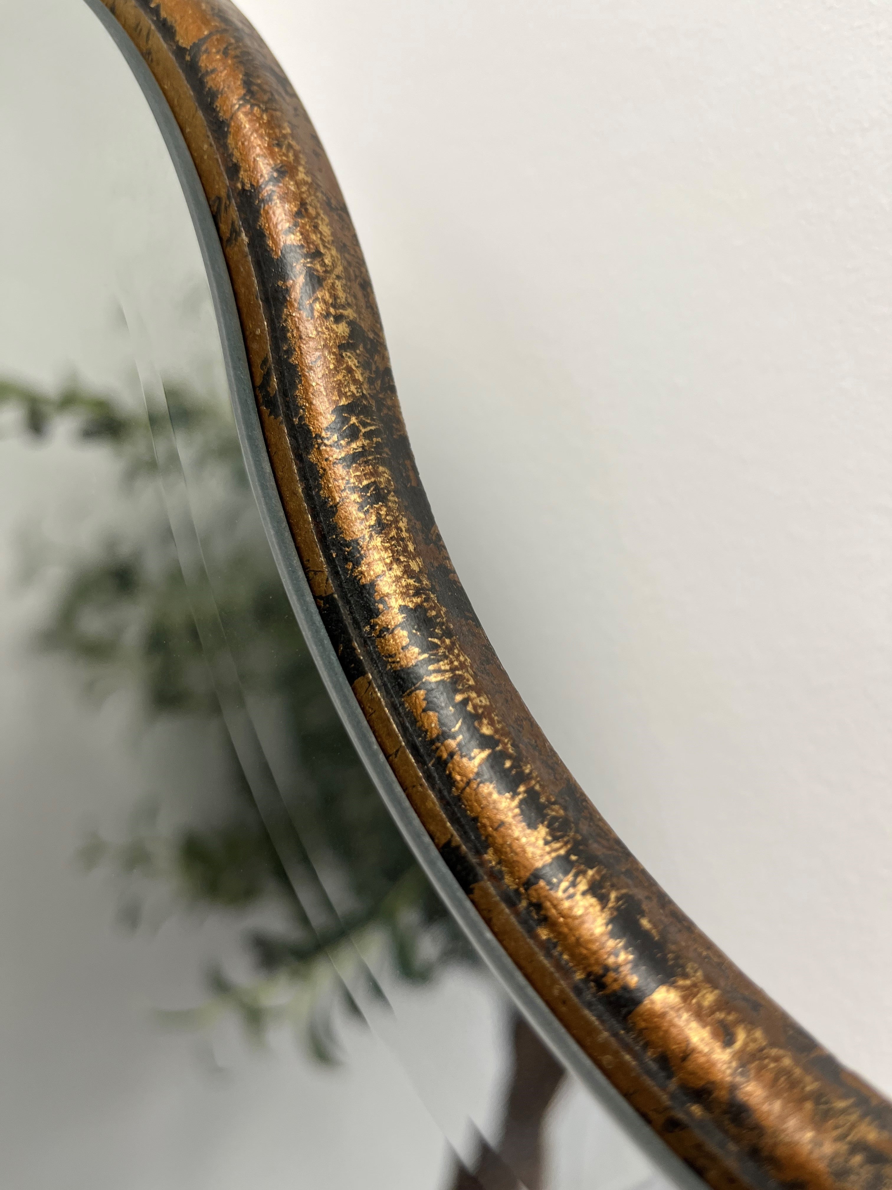 A beautiful frameless arched mirror.