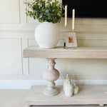 Large acacia wood console table supported by two balustrades