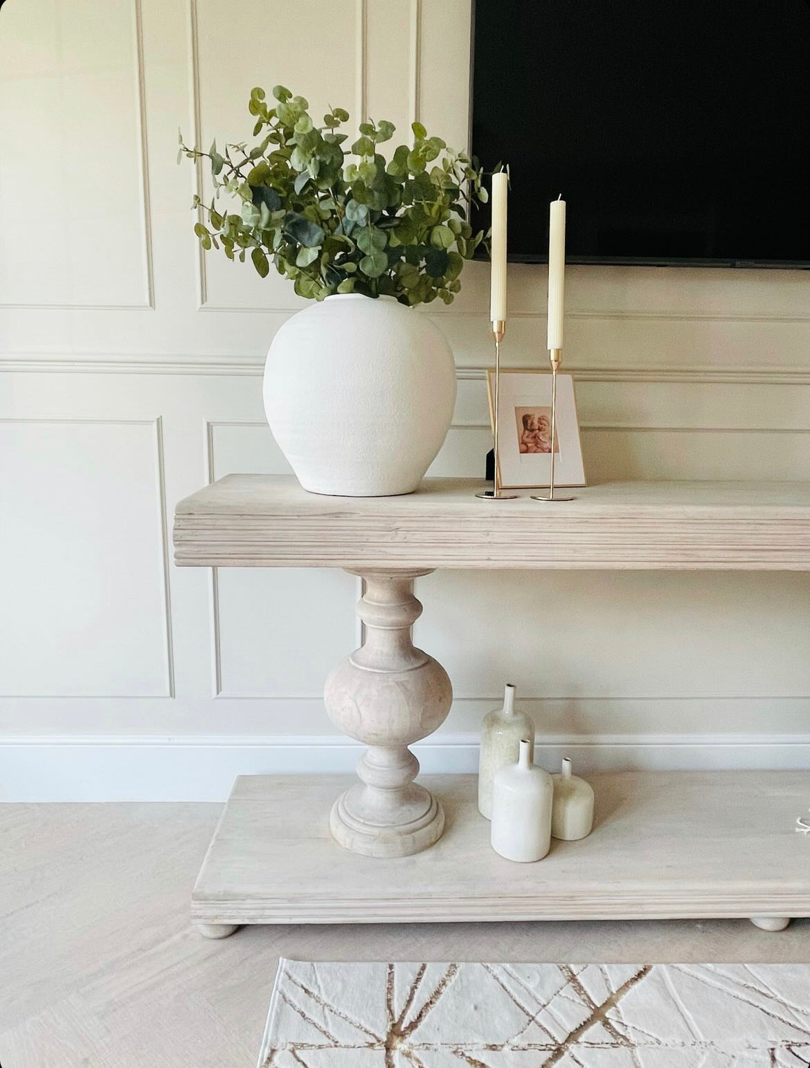 Large acacia wood console table supported by two balustrades