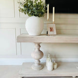Large acacia wood console table supported by two balustrades