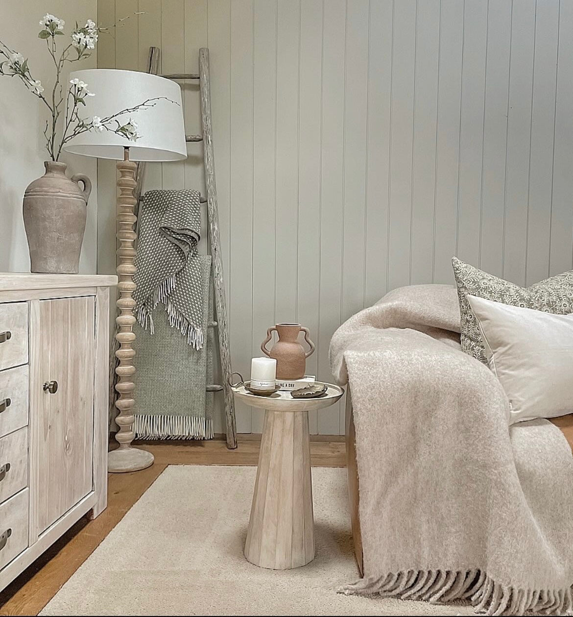 A stunning floor lamp in a beautiful turned pale wood complete with off white linen shade.