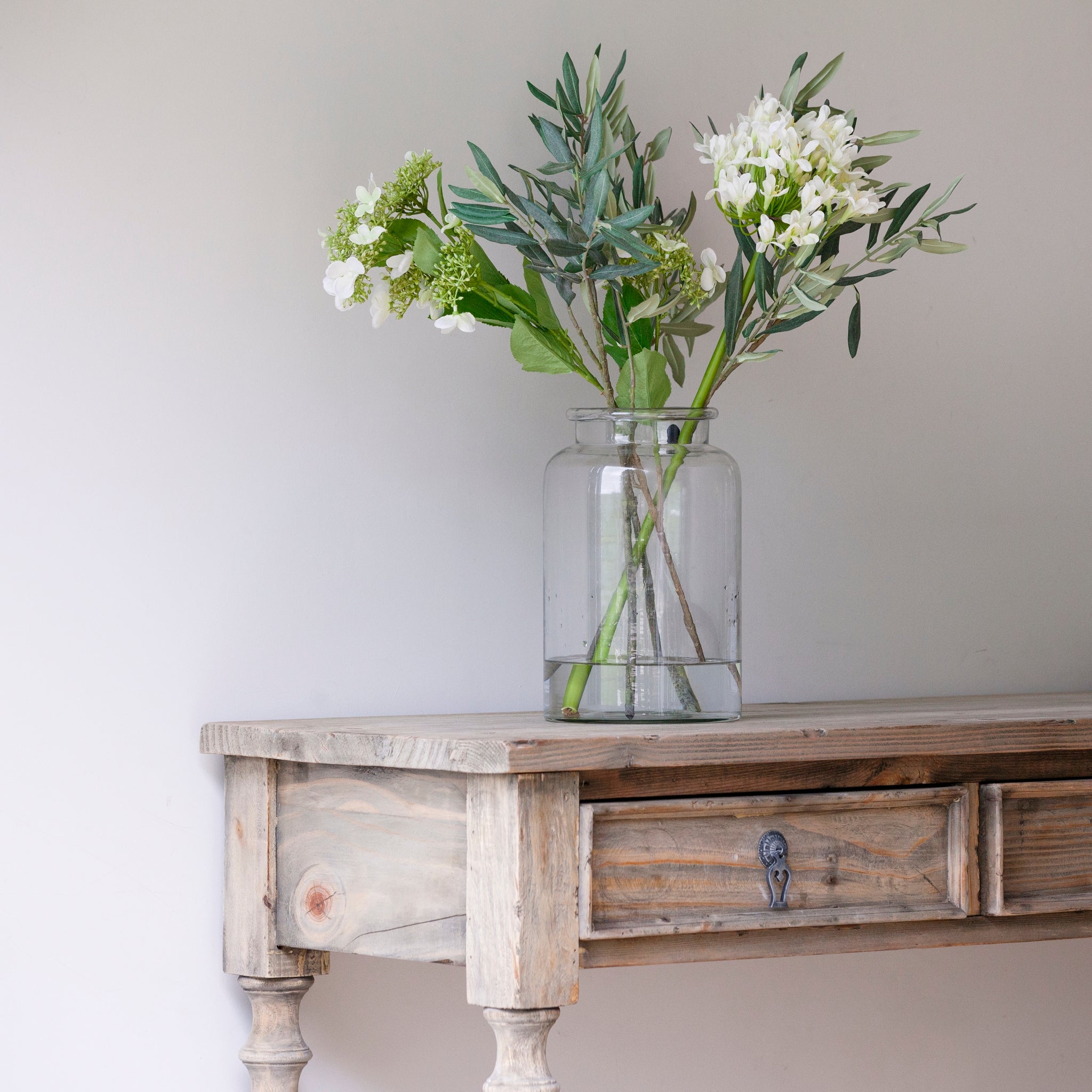 Three-drawer console table made from reclaimed, weathered pine